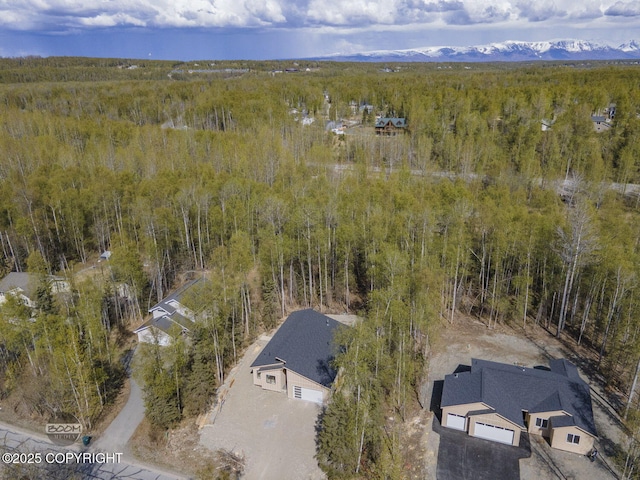 view from above of property with a heavily wooded area