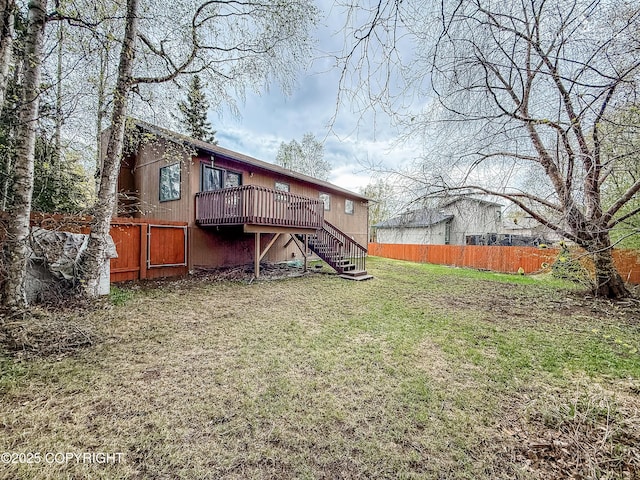 rear view of property with stairs and a wooden deck