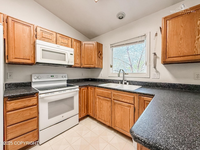 kitchen featuring white appliances, a sink, vaulted ceiling, dark countertops, and brown cabinetry
