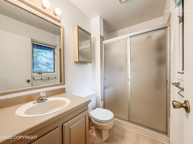 full bathroom with a stall shower, toilet, tile patterned flooring, and vanity