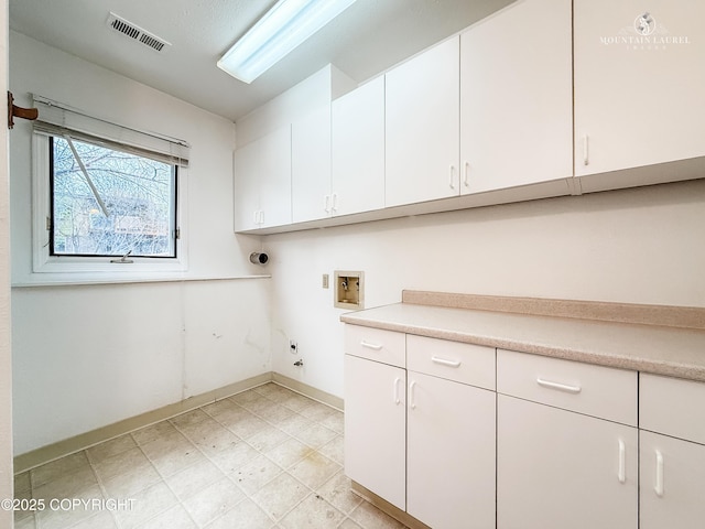 laundry area with cabinet space, washer hookup, baseboards, electric dryer hookup, and hookup for a gas dryer