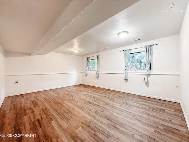empty room featuring wood finished floors and baseboards
