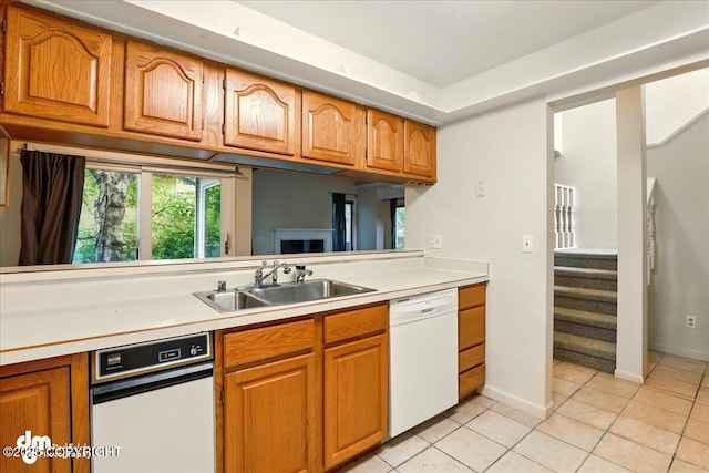 6508 Cimarron Cir, Anchorage, AK 99504 - kitchen with white dishwasher, a sink, brown cabinets, and light countertops