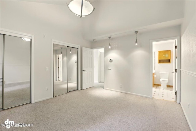 6508 Cimarron Cir, Anchorage, AK 99504 - unfurnished bedroom with two closets, carpet, connected bathroom, and baseboards