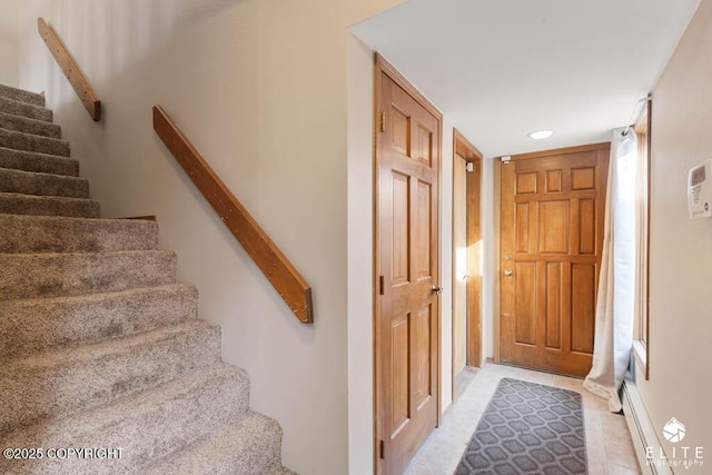 staircase featuring tile patterned flooring and recessed lighting