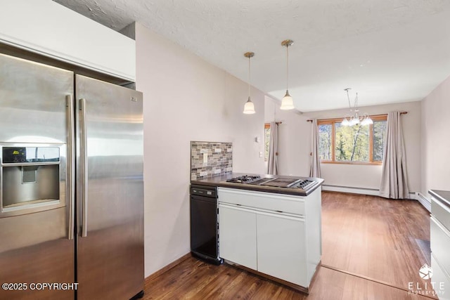 kitchen featuring a peninsula, backsplash, dark wood-style floors, white cabinets, and appliances with stainless steel finishes