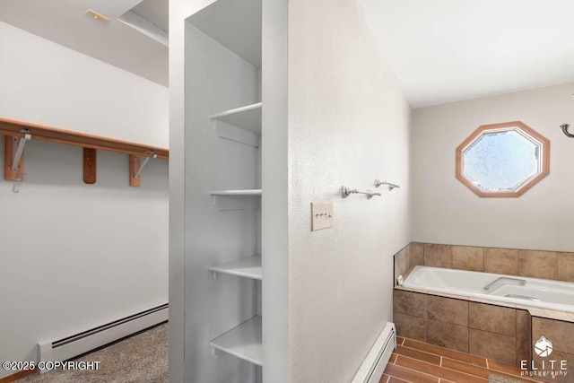 bathroom featuring a baseboard radiator, a garden tub, and wood finished floors
