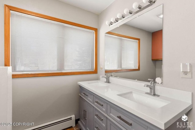 full bath with a baseboard radiator, double vanity, and a sink