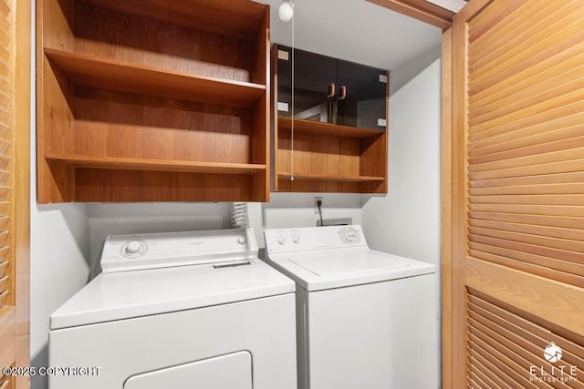 laundry area with washing machine and clothes dryer and laundry area
