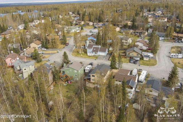 bird's eye view with a wooded view and a residential view
