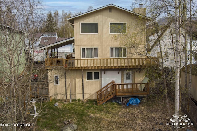back of house featuring a chimney and a deck