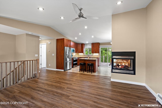 3520 Glenn-Don Cir, Anchorage, AK 99504 - unfurnished living room featuring a baseboard heating unit, wood finished floors, lofted ceiling, a ceiling fan, and recessed lighting
