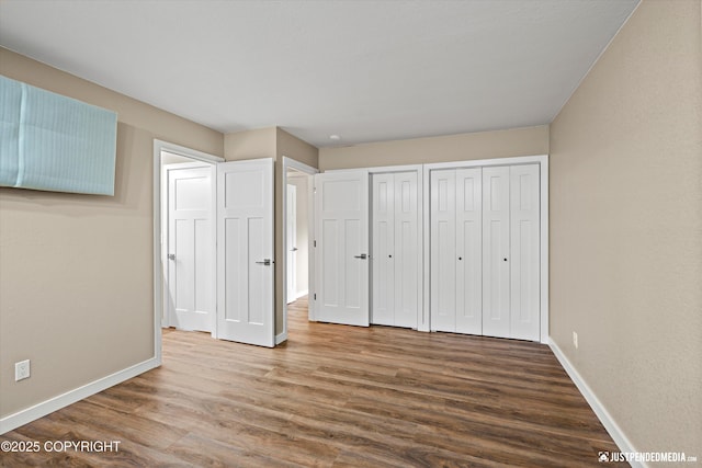 3520 Glenn-Don Cir, Anchorage, AK 99504 - unfurnished bedroom featuring wood finished floors and two closets