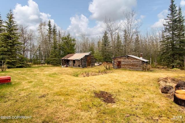 265 Ames Rd, Kenai, AK 99611 - view of green lawn featuring an outbuilding and a view of trees