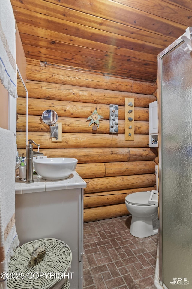 265 Ames Rd, Kenai, AK 99611 - bathroom with wood ceiling, vanity, a stall shower, toilet, and brick patterned floors