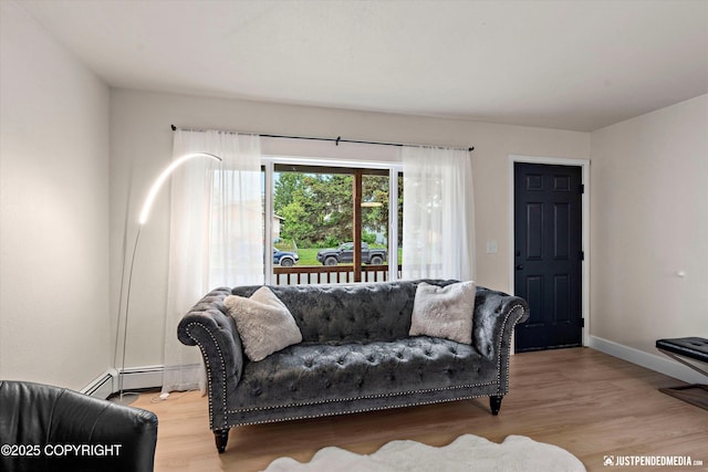 3722 E 19th Ave, Anchorage, AK 99508 - living area featuring light wood finished floors and a baseboard heating unit