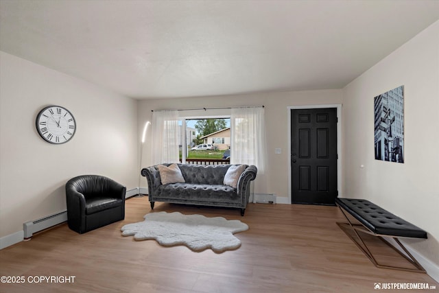 3722 E 19th Ave, Anchorage, AK 99508 - living room featuring a baseboard radiator and wood finished floors