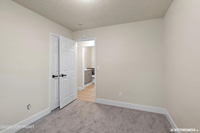 3722 E 19th Ave, Anchorage, AK 99508 - empty room featuring light carpet and a textured ceiling