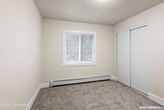 3722 E 19th Ave, Anchorage, AK 99508 - unfurnished bedroom with baseboard heating, carpet flooring, and a closet