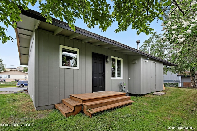 3722 E 19th Ave, Anchorage, AK 99508 - rear view of house featuring a lawn