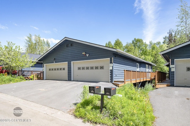 2563 La Honda Dr, Anchorage, AK 99517 - view of front of house with a garage, a deck, and an outbuilding