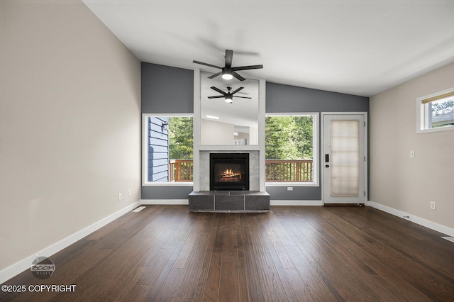 2563 La Honda Dr, Anchorage, AK 99517 - living room with vaulted ceiling, a ceiling fan, a tile fireplace, wood finished floors, and baseboards