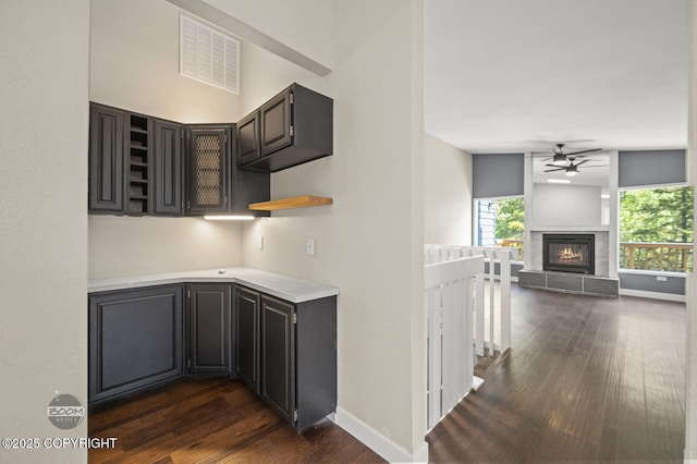 2563 La Honda Dr, Anchorage, AK 99517 - kitchen featuring open shelves, dark wood-style floors, ceiling fan, light countertops, and plenty of natural light