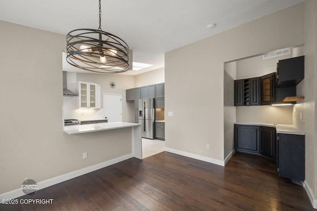 2563 La Honda Dr, Anchorage, AK 99517 - kitchen featuring stainless steel appliances, dark wood-style flooring, light countertops, and a peninsula