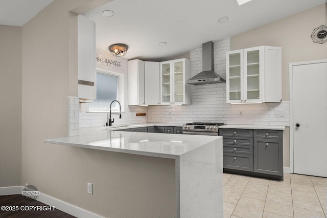 2563 La Honda Dr, Anchorage, AK 99517 - kitchen with wall chimney exhaust hood, gray cabinets, stainless steel gas range, and backsplash
