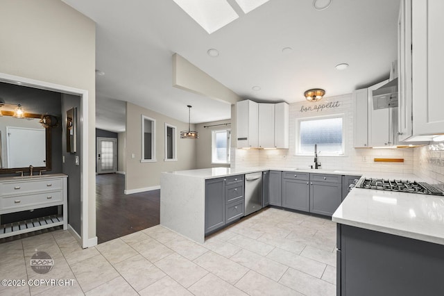 2563 La Honda Dr, Anchorage, AK 99517 - kitchen featuring stainless steel appliances, gray cabinetry, a sink, tasteful backsplash, and recessed lighting