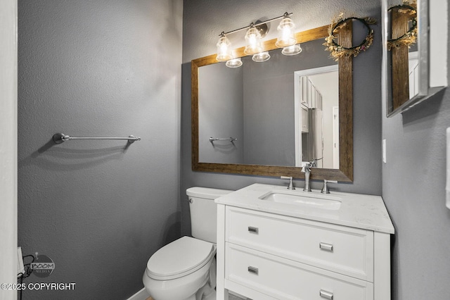 2563 La Honda Dr, Anchorage, AK 99517 - bathroom with vanity, toilet, and a textured wall