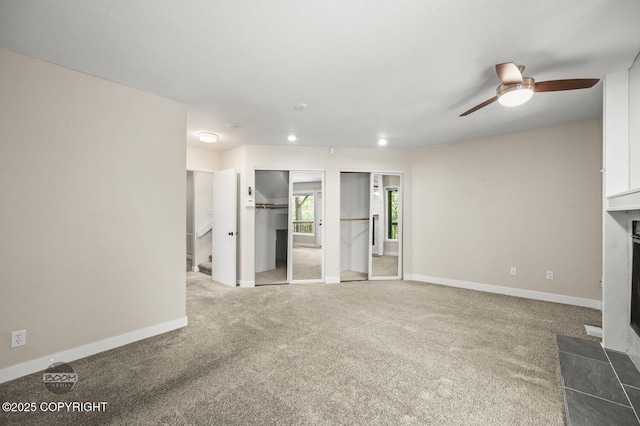 2563 La Honda Dr, Anchorage, AK 99517 - unfurnished living room featuring carpet, ceiling fan, baseboards, and recessed lighting