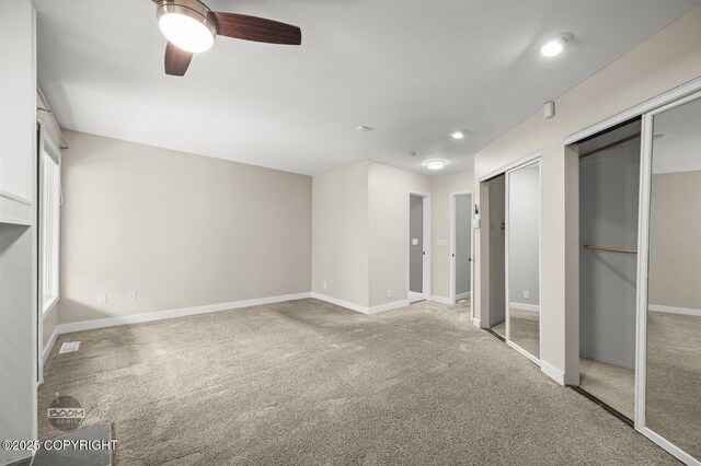 2563 La Honda Dr, Anchorage, AK 99517 - unfurnished bedroom featuring two closets, carpet floors, and baseboards