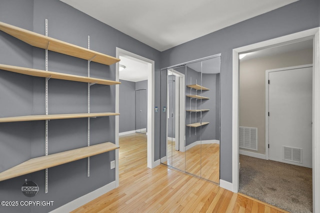 2563 La Honda Dr, Anchorage, AK 99517 - walk in closet featuring wood finished floors