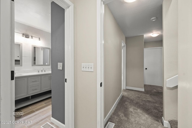 2563 La Honda Dr, Anchorage, AK 99517 - hall with a sink and baseboards
