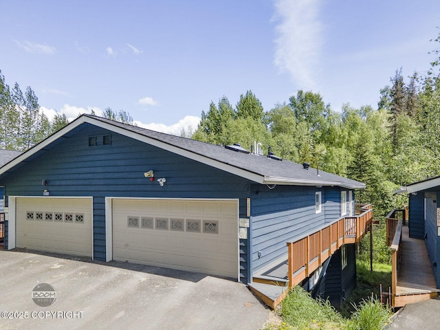 2563 La Honda Dr, Anchorage, AK 99517 - view of front facade featuring a garage, a deck, and stairway