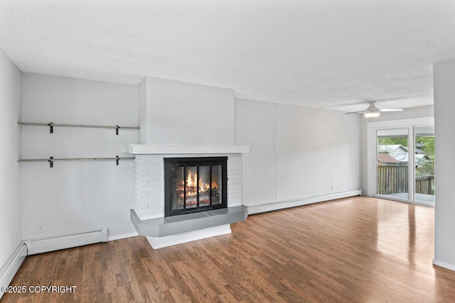3921 Patricia Ln, Anchorage, AK 99504 - unfurnished living room featuring baseboard heating, wood finished floors, a textured ceiling, a brick fireplace, and baseboards