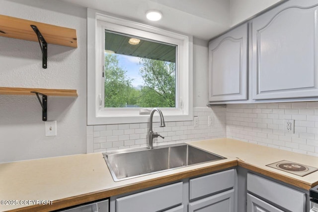 3921 Patricia Ln, Anchorage, AK 99504 - kitchen featuring a sink, backsplash, light countertops, and gray cabinets