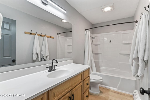 3921 Patricia Ln, Anchorage, AK 99504 - full bath with toilet, wood finished floors, vanity, shower / bath combo, and a baseboard heating unit