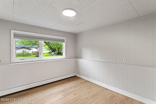 3921 Patricia Ln, Anchorage, AK 99504 - spare room with a baseboard heating unit and wood finished floors