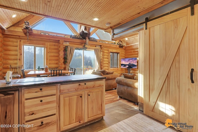 19180 Beverly Ave, Chugiak, AK 99567 - kitchen with rustic walls, wooden ceiling, light brown cabinets, healthy amount of natural light, and dark countertops