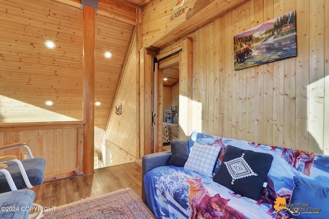 19180 Beverly Ave, Chugiak, AK 99567 - living area with wooden walls, hardwood / wood-style floors, and vaulted ceiling