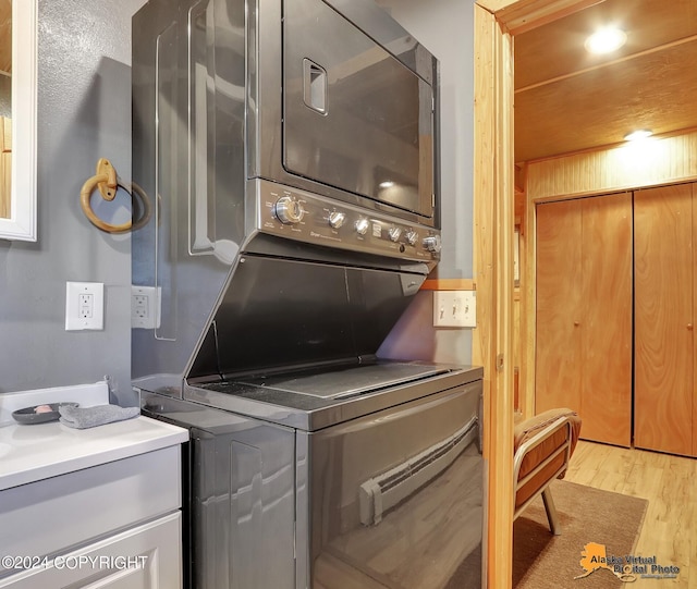 19180 Beverly Ave, Chugiak, AK 99567 - laundry room with stacked washing machine and dryer and light wood-style floors