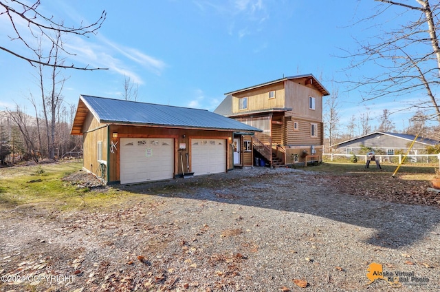 19180 Beverly Ave, Chugiak, AK 99567 - back of property with a detached garage, a metal roof, and an outbuilding