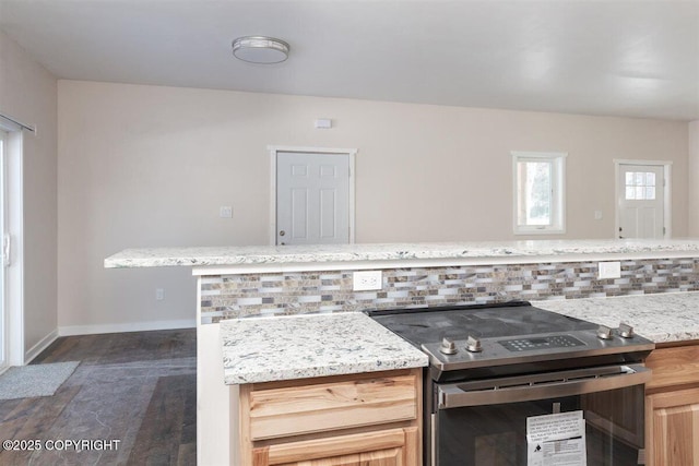 2429 Outside Blvd, North Pole, AK 99705 - kitchen featuring stainless steel electric range, dark wood-type flooring, light stone countertops, and decorative backsplash