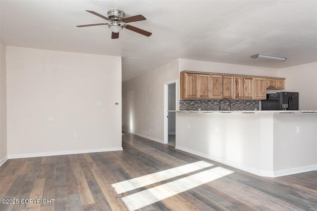 2429 Outside Blvd, North Pole, AK 99705 - kitchen with fridge, ceiling fan, light countertops, and dark wood-style floors