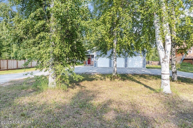 2429 Outside Blvd, North Pole, AK 99705 - obstructed view of property featuring a garage, an outdoor structure, and asphalt driveway