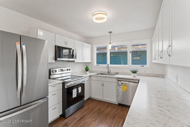 906 Lancaster Dr, Anchorage, AK 99503 - kitchen featuring appliances with stainless steel finishes, a sink, white cabinetry, and dark wood-style flooring