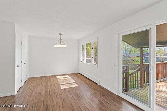 906 Lancaster Dr, Anchorage, AK 99503 - unfurnished dining area featuring baseboard heating, wood finished floors, and baseboards