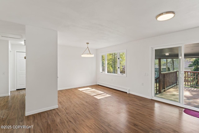 906 Lancaster Dr, Anchorage, AK 99503 - empty room featuring a baseboard heating unit, wood finished floors, and baseboards